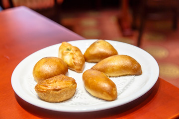 A variety of small cakes are on the plate.