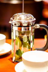 tea with mint and ginger in a glass teapot (French press).