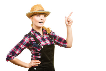 Woman wearing sun hat, pointing at something