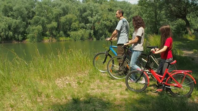 Family on mountain bikes. Active recreation in nature.