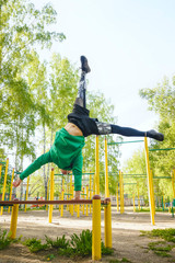 Fototapeta premium Fitness man at the bar. Exercising outdoors in the Park. Street workout.