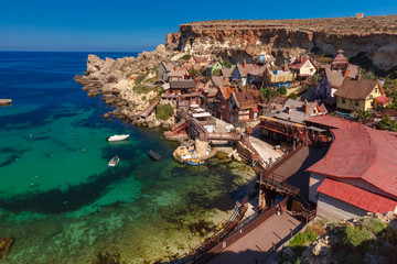 Traditional colorful houses in the famous Popeye Village at Anchor Bay, Il-Mellieha, Malta