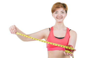 Healthy lifestyle, healthy eating. A young girl holds an apple and a measuring tape, on a white background. Horizontal frame