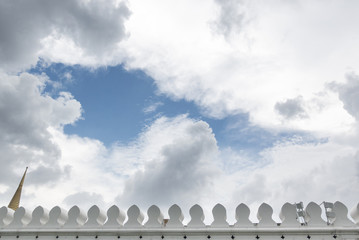 Sky and clouds with temple wall in Bangkok, Thailand.