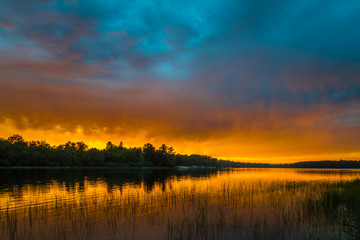 Fototapeta na wymiar Sunset above forest lake