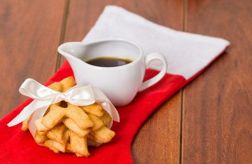 Closeup of delicious ecuadorian pristinos, tied up with white ribbon for a nice presentation, traditional andean pastry, coffee cup sitting besides