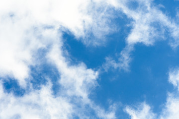 Bright blue sky with white cloud occupying half of the frame