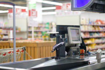 Close up of empty cash desk terminal with computer screen and belt