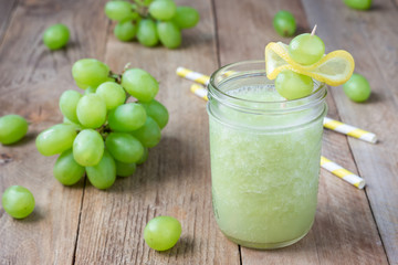 Healthy smoothie with green grape, lemon and honey in glass jar, horizontal