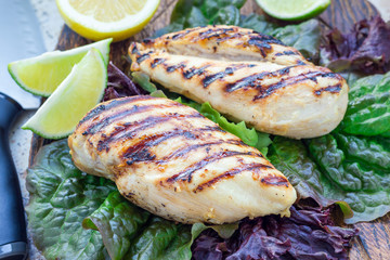 Grilled chicken breast on salad leaves, horizontal