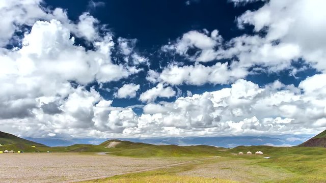 Clouds over the field in the highlands. Time Lapse
