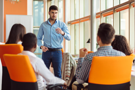 business, startup, presentation, strategy and people concept - man making presentation to creative team at office