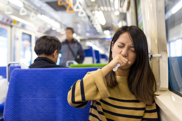 Woman feeling sick in train compartment