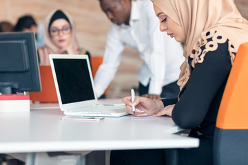 Young Arabic business woman wearing hijab,working in her startup office.
