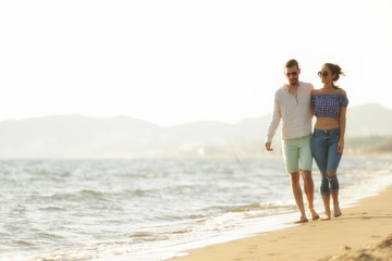 Fototapeta na wymiar happy couple waling on the beach and having fun