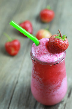 Strawberry Smoothies in Glass on foods table floor.