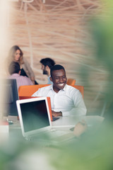 Young African-American business man taking a break at his desk