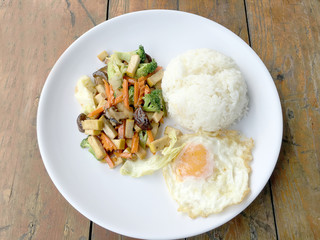 Stir Fried Tofu in Chinese Style, Deep Fried Tofu with Gravy Sauce ,Stir fried tofu with mixed vegetables and fried egg  in white plate on white background. Vegetarian Food, healthy food.