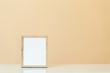 Blank picture frame on a yellow background