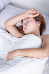 Fototapeta na wymiar Woman sleeping on bed in bedroom