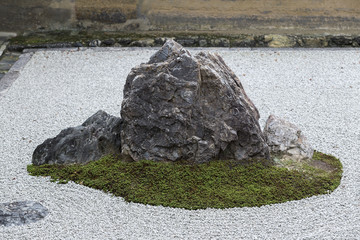 Zen Rock Garden in Ryoan-ji Temple.In a garden fifteen stones on white gravel, Kyoto, Japan