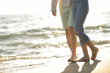 Legs of couple on the sand beach