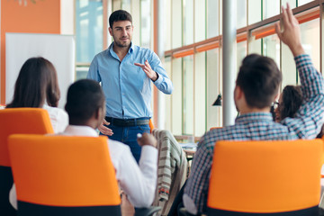 business, startup, presentation, strategy and people concept - man making presentation to creative team at office