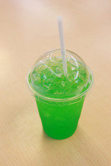 Green soda in the glass.