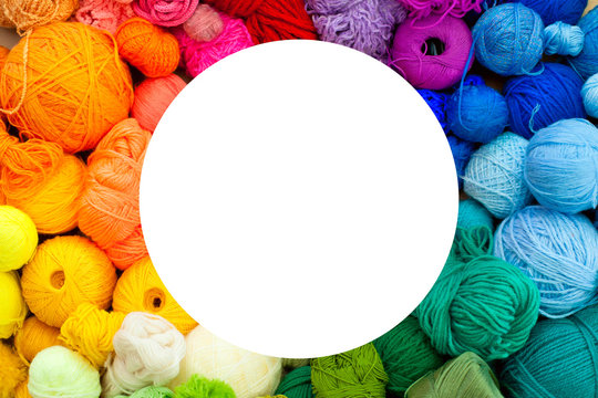 Colorful yarn stacked in a series of colors. Background brown kraft paper.  Balls and skeins of colored yarn for knitting. The color wheel of the yarn.  Stock Photo