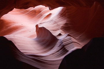 Nature red sandstone textured background. Swirls of old red  sandstone wall abstract pattern in Lower Antelope Canyon, Page, Arizona, USA.