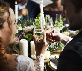 Bride and Groom Clinging Wineglasses Together at Wedding Reception