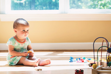 Toddler girl playing in her house