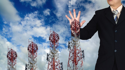 Double exposure of businessman touching telecommunication tower background.