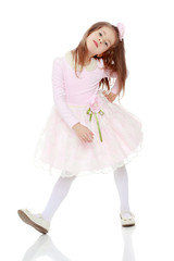Elegant little girl in a pink dress.