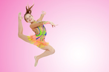 Girl gymnast performs a jump.