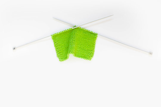 Knitted green. Yarn for knitting green. White background.