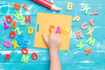Children play plastic letters to combinations word 