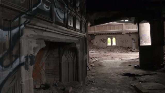 POV: Urban exploration of spooky abandoned City Methodist Church in Gary, USA. Big religious building collapsing. Graffiti on the walls, ruined pillars, broken dusty planks and demolished fireplace