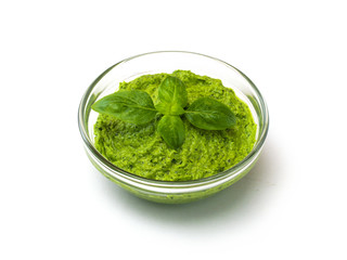 Green pesto sauce and basil, isolated on white. 