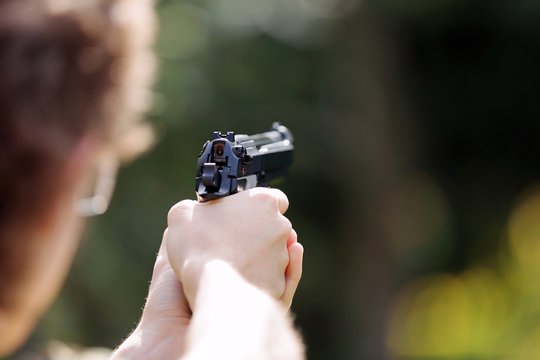 Young boy practice shooting guns on outdoor