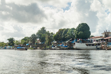 Fototapeta na wymiar OIAPOQUE, BRAZIL - AUGUST 1, 2015: Small boats on Oiapok (Oiapoque or Oyapock) river in Oiapoque town.