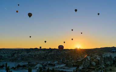 Hot air balloons flying over valley at sunrise. Cappadocia. Turkey