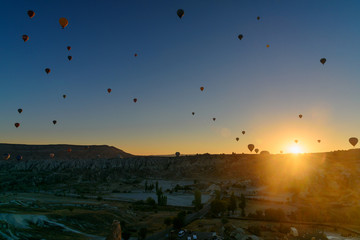 Hot air balloons flying over valley at sunrise. Cappadocia. Turkey