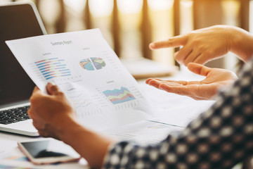 Two business woman investment consultant analyzing company annual financial report balance sheet statement working with documents graphs. Concept picture of economy, market, office,money and tax.