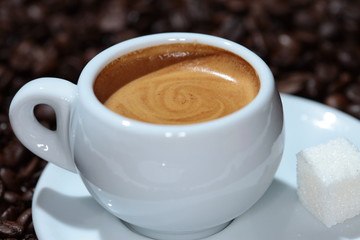 cup of coffee on the background of coffee beans