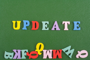 UPDEATE word on green background composed from colorful abc alphabet block wooden letters, copy...