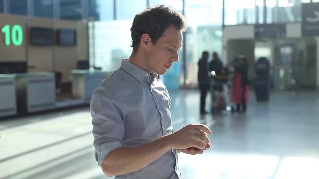 man checking boarding pass and number of gate in the airport