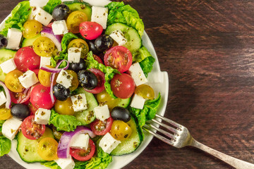 Greek salad with feta, fresh vegetables, and copyspace