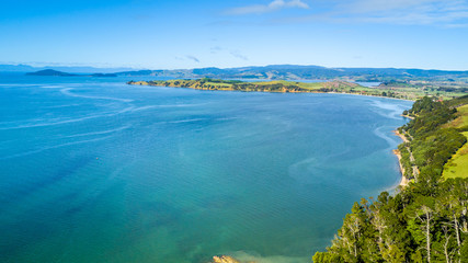Fototapeta na wymiar Aerial view on beautiful harbour with sunny beach and surrounding hillside, New Zealand