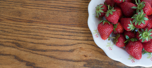 Home grown strawberries on the wooden background
